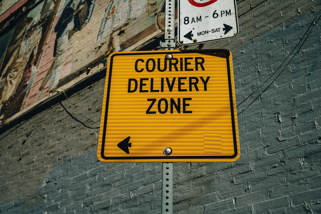 Courier delivery zone sign on a city street indicating delivery regulations.