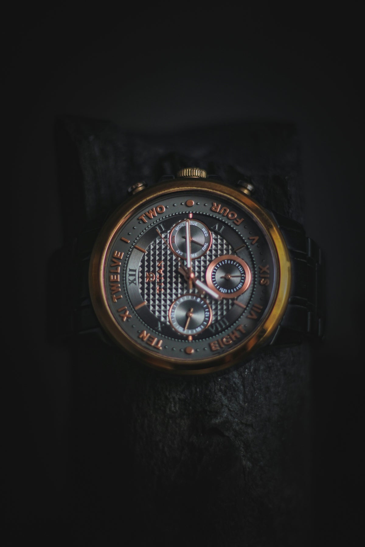 a close up of a watch on a black surface