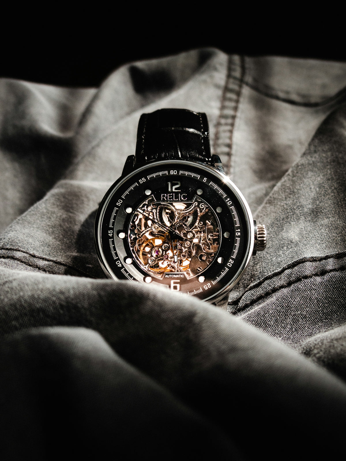 a close up of a watch on a person's lap