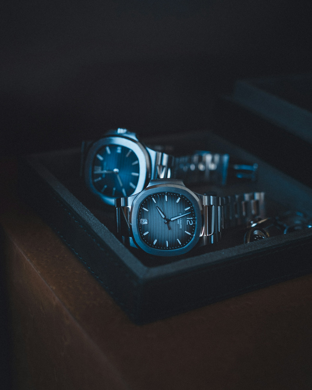 A couple of watches sitting on top of a table