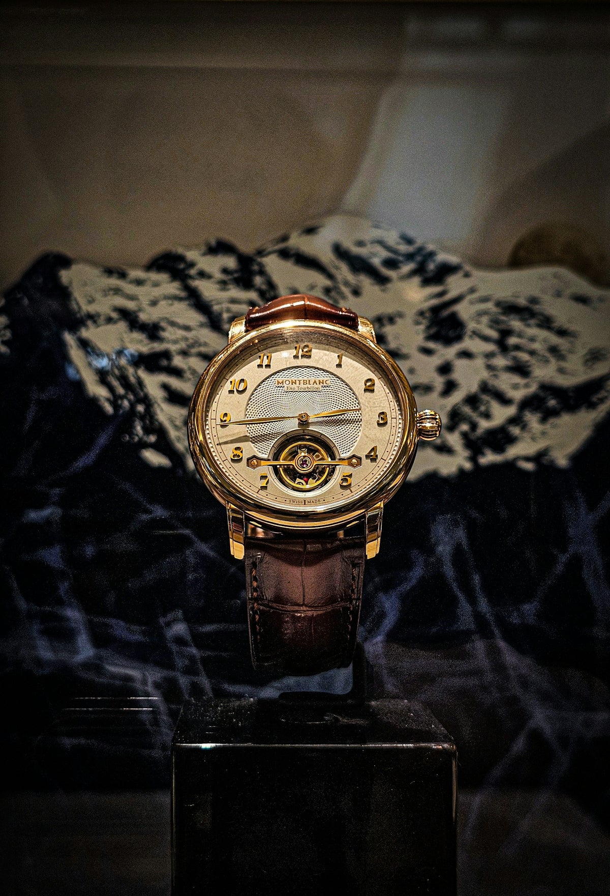 A watch on display in a glass case