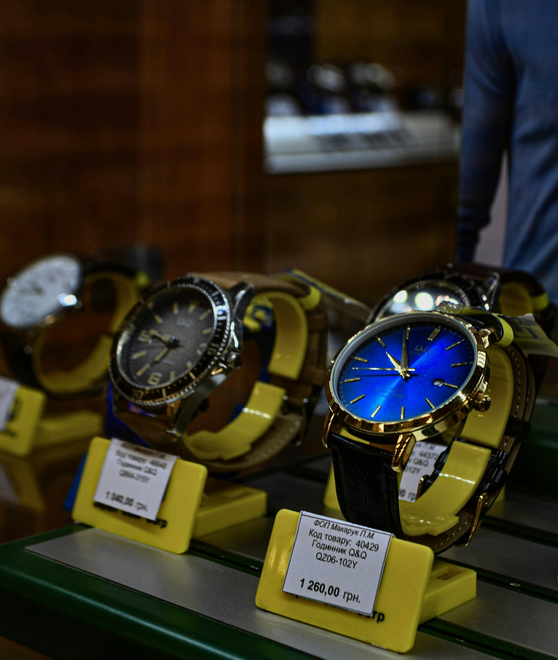 Luxury wristwatches displayed on stands in a store.