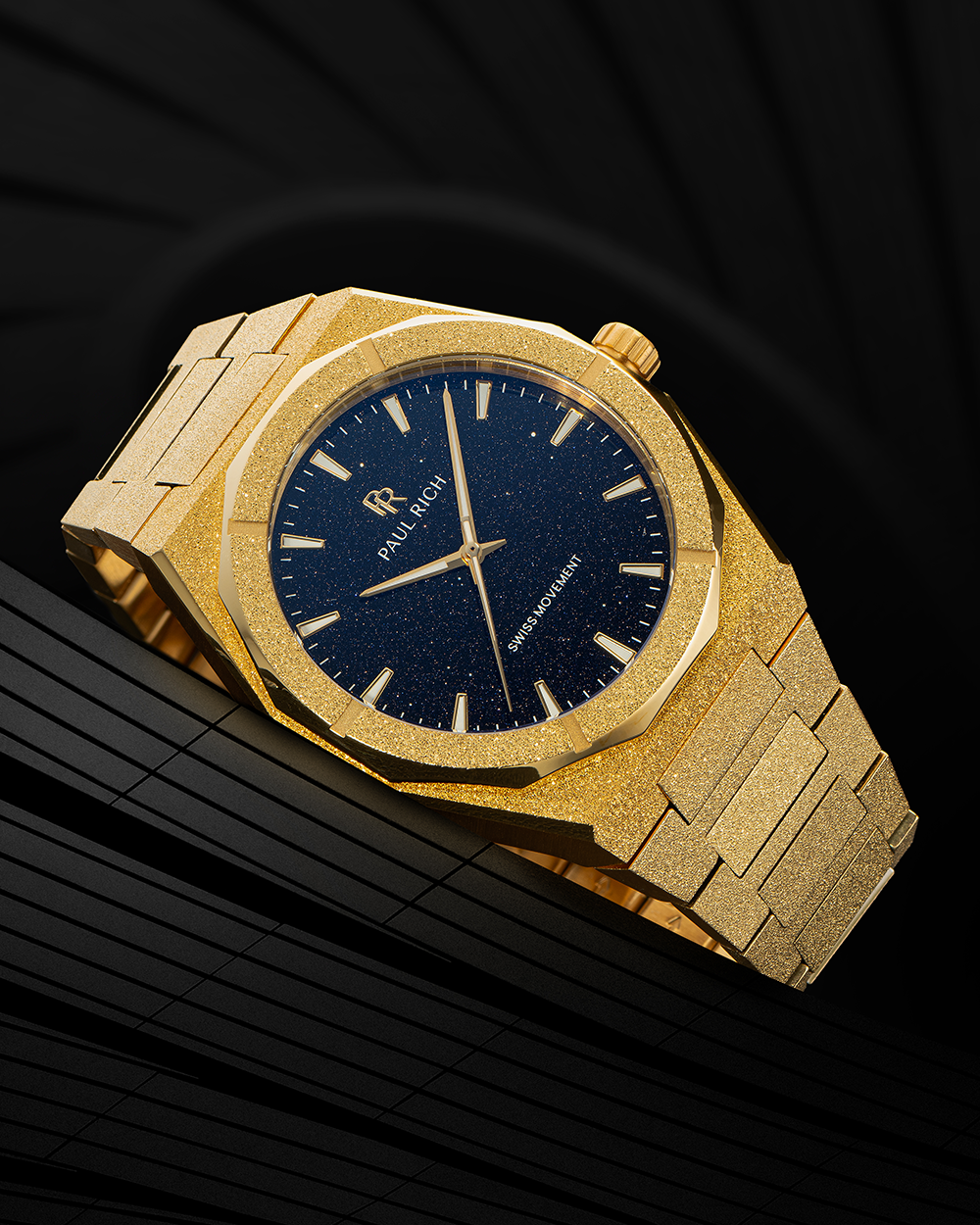 Gold watch with a dark blue face on a black background