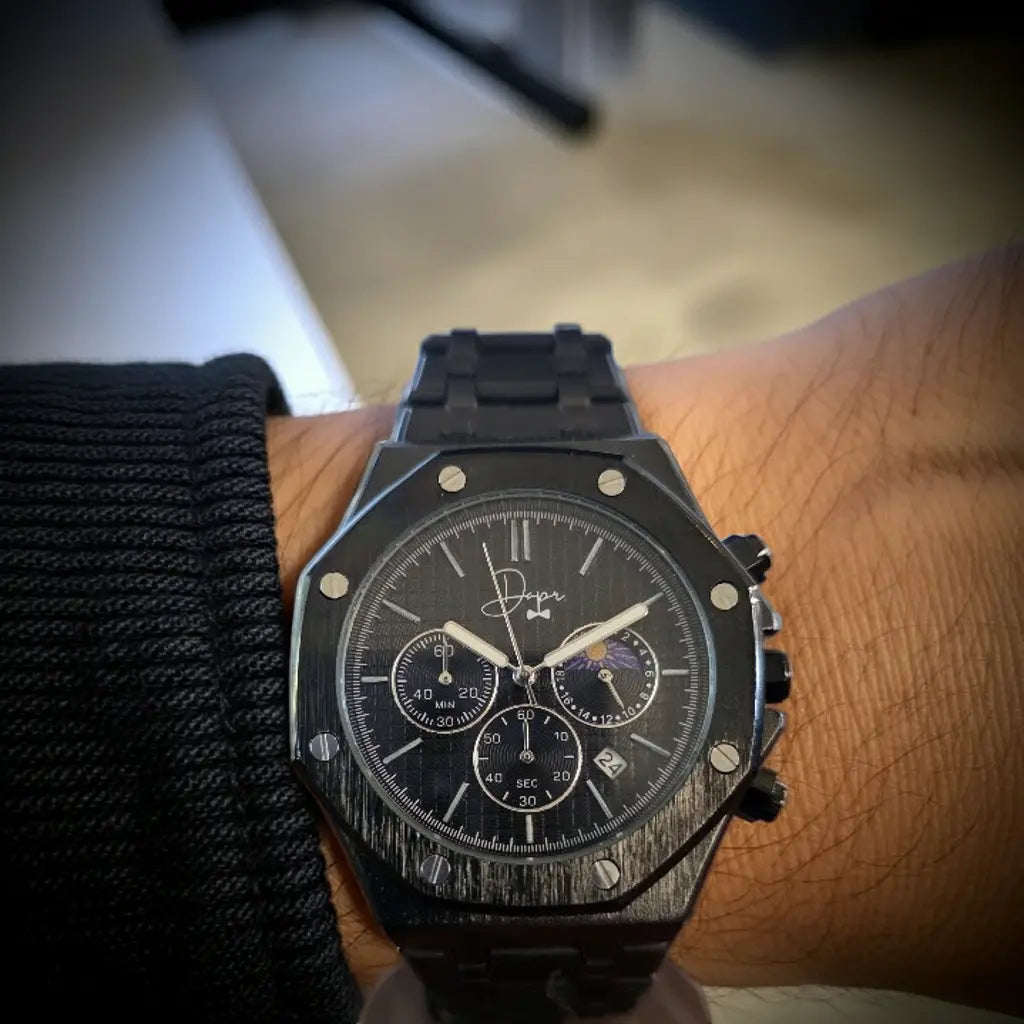 Black ceramic watch with a textured, brushed finish and three subdials on the face.