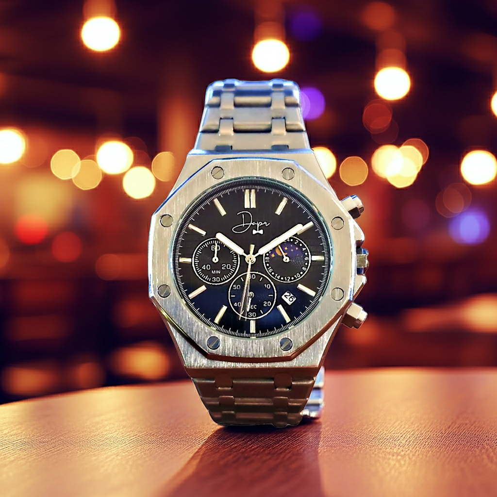 Luxury watch with a black dial on a wooden surface with blurred lights in the background