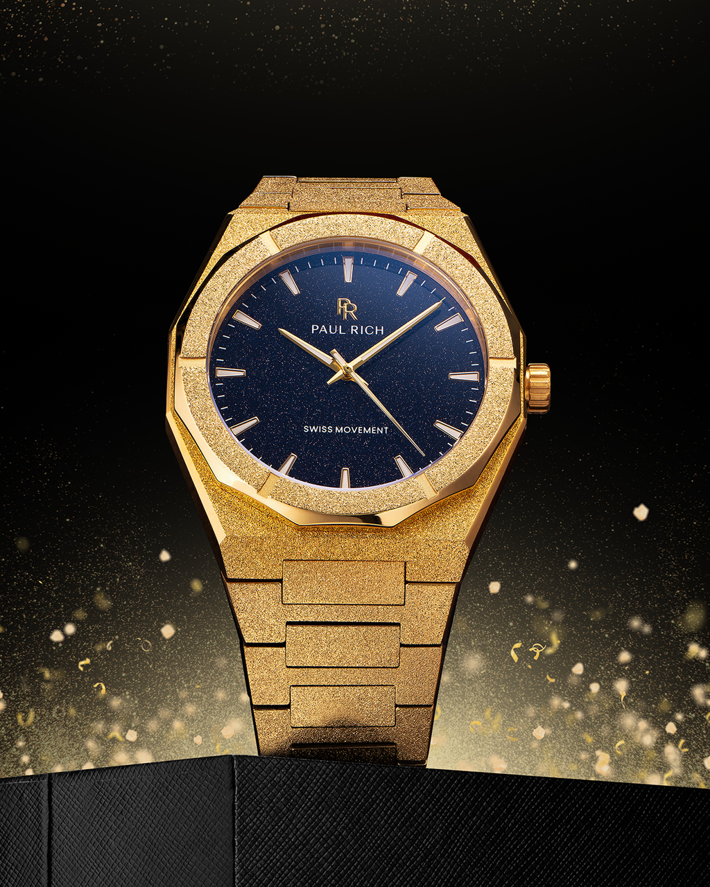 Gold watch with blue dial on a dark background