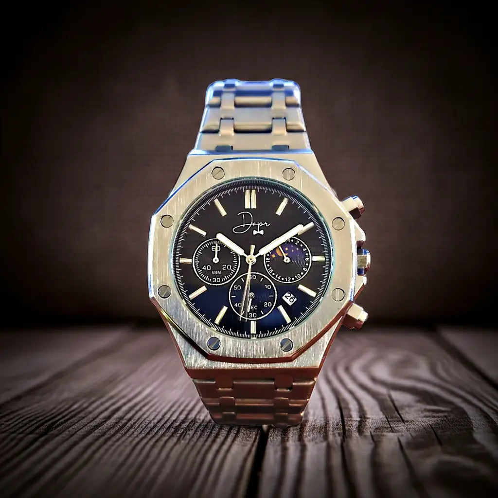 A sleek, brushed stainless steel chronograph watch with a black dial featuring gold-toned hands and markers, three subdials for timing functions, and the brand name ’dopp’ elegantly scripted above the 12 o’clock position.