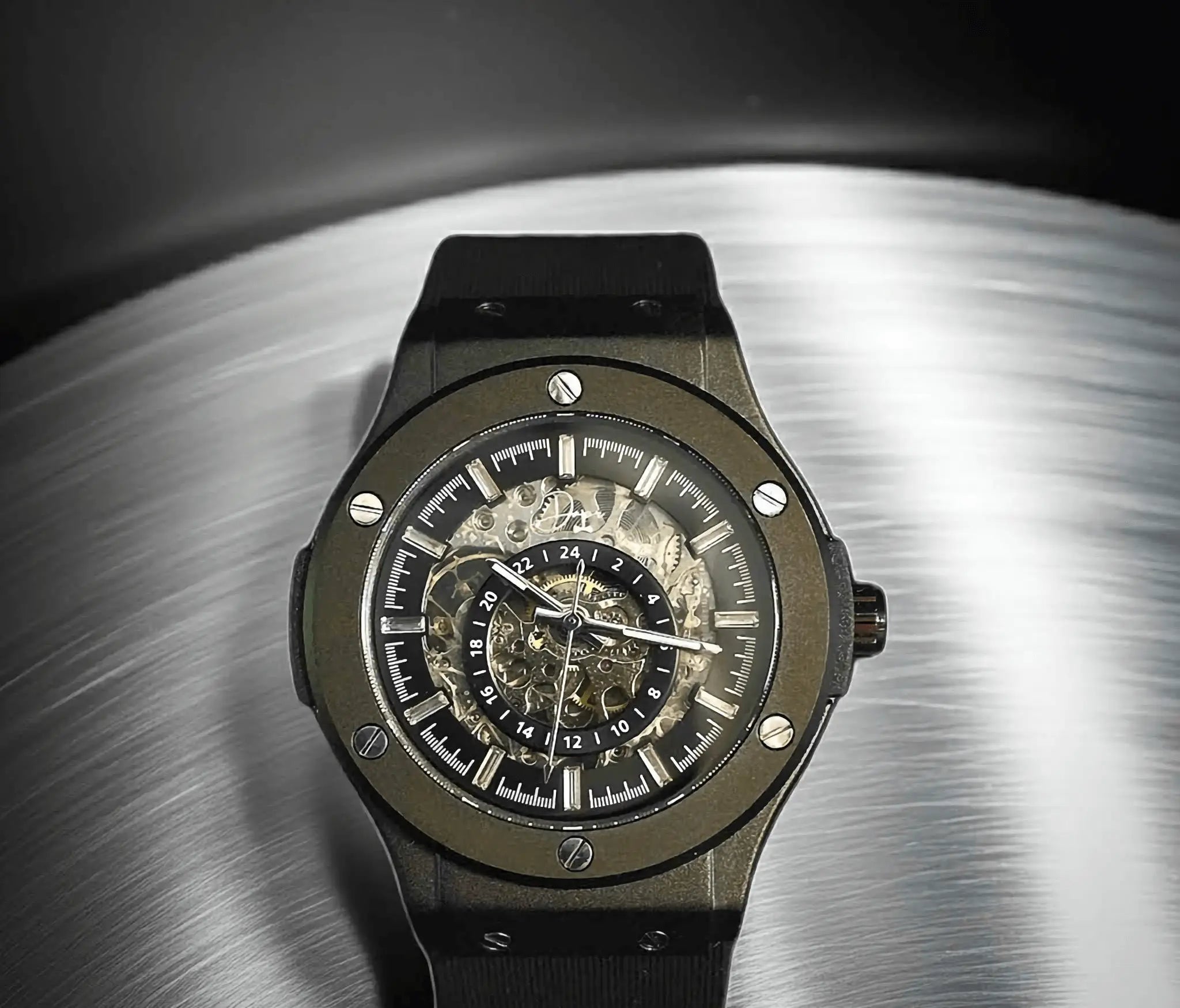 Black ceramic and steel hublot big bang skeleton watch with a transparent dial revealing its intricate mechanical movement.